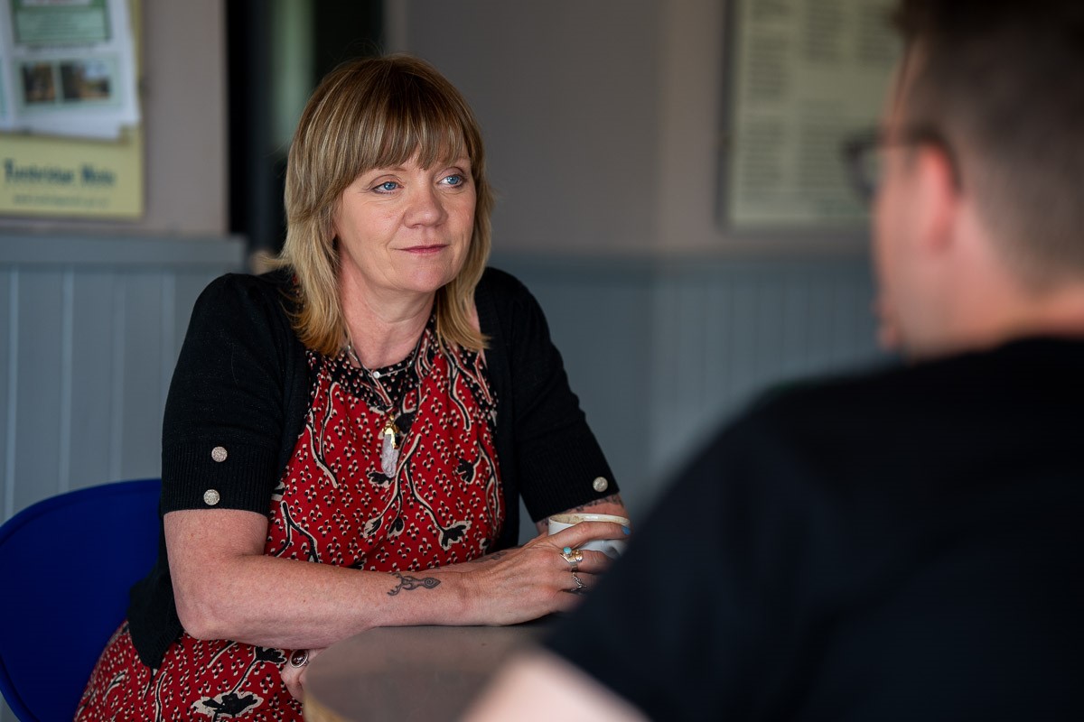 A Look Ahead Domestic Abuse support worker speaking to a man.